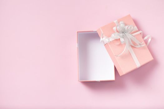 Gift box open empty on pink background