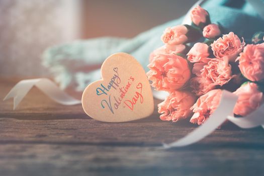 Happy valentines day message on heart wood with sweet flowers