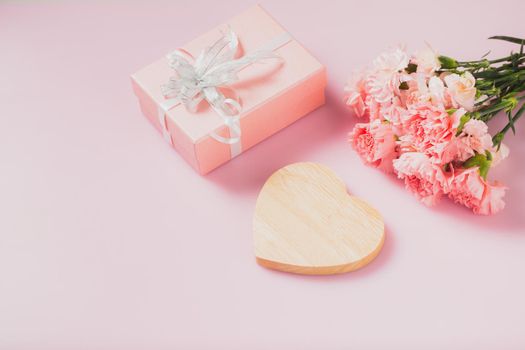 Heart wooden empty for message with gift box and Carnation flowers, Mother's Day and Valentines Day