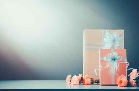 Still life with Gift Box and sweet Carnation flowers on table, Mothers day concept