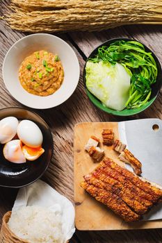 Roast Pork Belly on wooden chopping board with knife