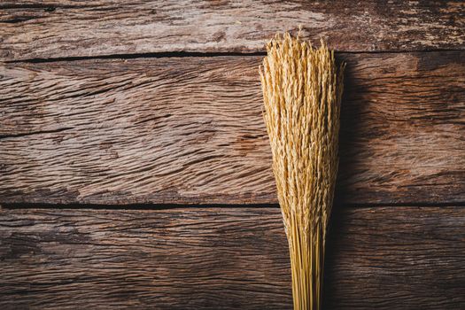 Rice dried bouquet with copy space on old wood background