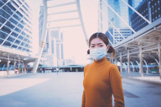 Portrait Woman wearing a mask on the city hallway