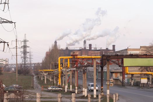 smoke chimneys on a large industrial complex. You can see pipelines, high-voltage power lines, and production workshops. Gorishni plavni, Ukraine, Ferrexpo