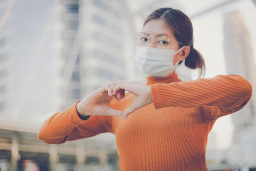 Woman making hands in heart shape, heart health insurance,social responsibility, donation, happy charity volunteer, world heart day, world mental health, cancer day, Valentines day