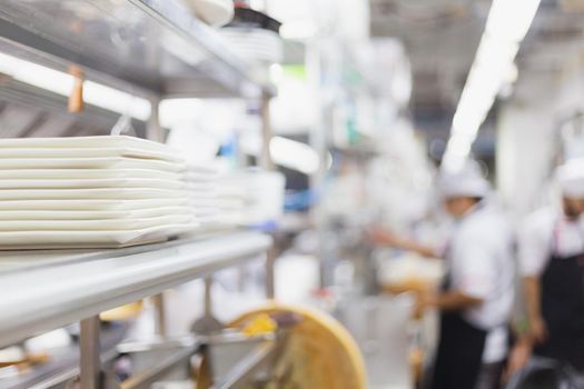 Blurred chefs of a restaurant kitchen background