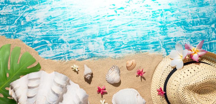 Summer concept, Beach accessories on the sand and blue wooden background with copy space