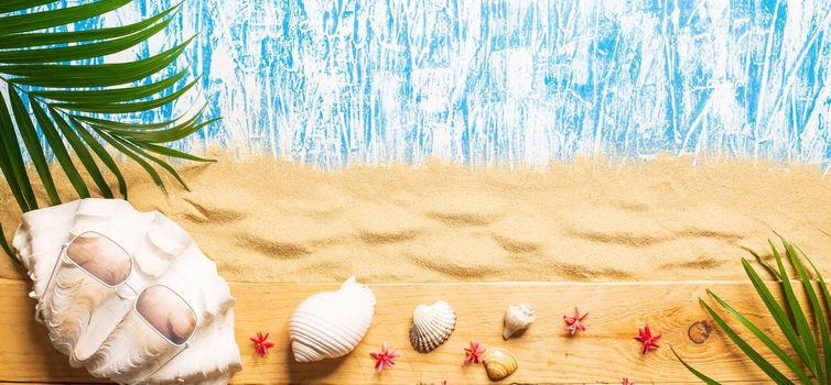 Summer background , Palm branch on sea sand background, space for text