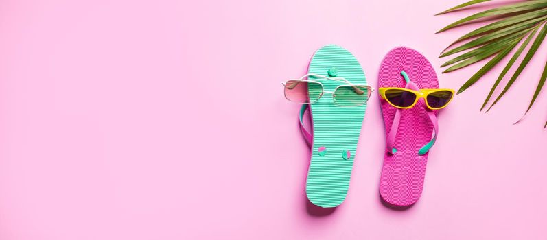 Summer background , Flip flop with palm branch  on pink background, space for text