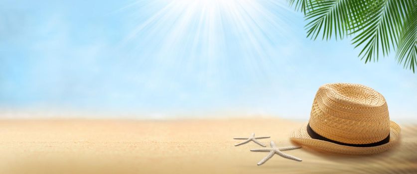 Travel background concept. Hat with starfish  on Beach blurred background