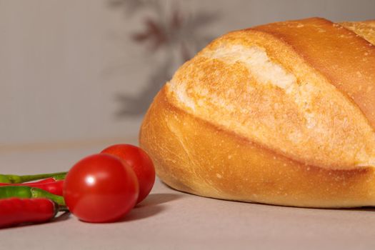 Close-up of fresh bread with peppers and tomatoes. Fresh bakery. Fried crust