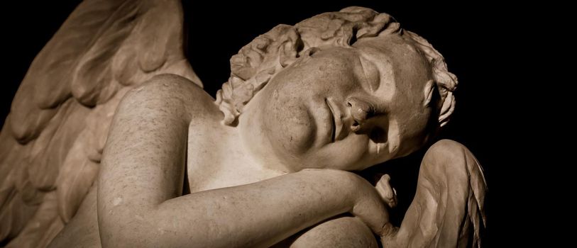 MILAN, ITALY - CIRCA AUGUST 2020: Cute sleeping angel. Statue made in marble, end of 18th century, unknown sculptor. Concept for sleep, innocence and newborrn.