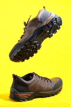 Men's shoes. Men's shoes, brown sneakers on a yellow background. High quality photo