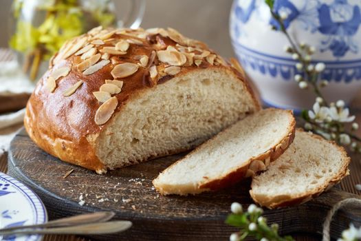 Sliced mazanec, traditional Czech sweet Easter pastry, similar to hot cross bun, with spring flowers