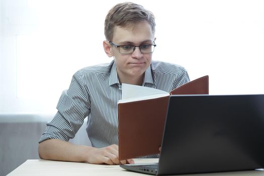 A young person has a remote job at the computer or training online. High quality photo