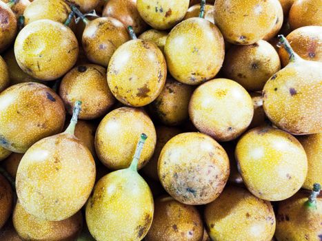 Many fresh yellow granadillas from the market.