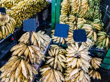 Sale of bananas in the market with empty signs where you can write something