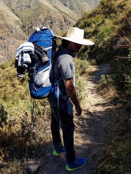 Man Traveler with hat and backpack hiking mountains Travel Lifestyle success concept adventure active summer vacations outdoor