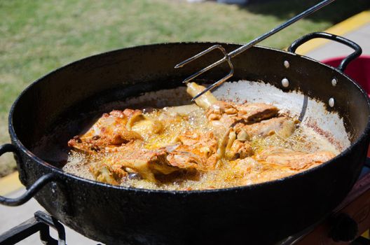 Chicken fried in a pan with hot oil, also known here in Peru as Pollada