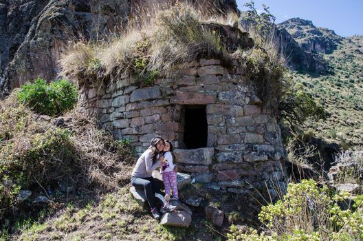 Girl and mom tourist making walks at the funerals of pumacoto in Canta - Peru