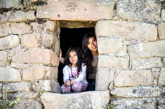 Girl and mom tourist making walks at the funerals of pumacoto in Canta - Peru