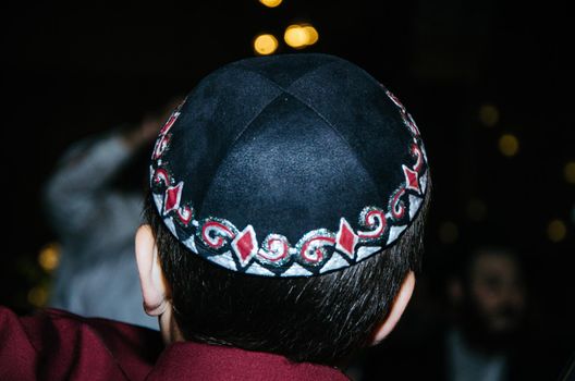 Back child wearing a Kippah at a wedding