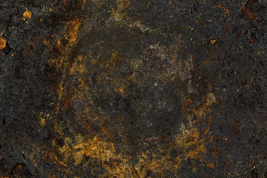 Bottom side of a cast iron pan with thicl layer of soot on its surface. Texture and background.