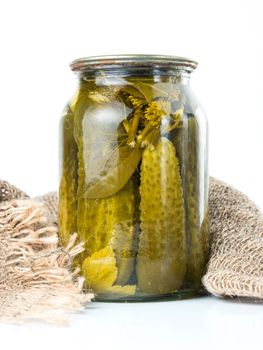 Pickled cucumbers isolated. Pickles in glass jar isolated on white background. Salted cucumber in jar isolated