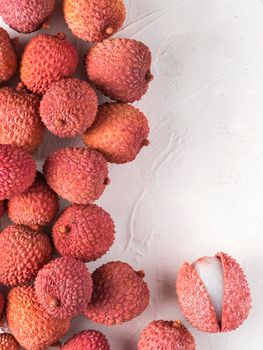 lichee fruit on white textured background. Lichee wit copy space. Top view or flat lay. Vertical