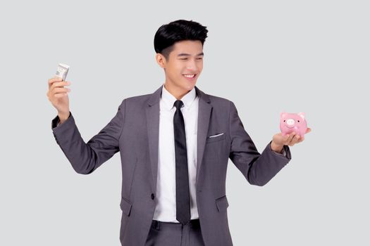 Young asian businessman in suit deposit money dollar with piggy bank isolated on white background, business man saving with planning budget and finance for success investment and financial.