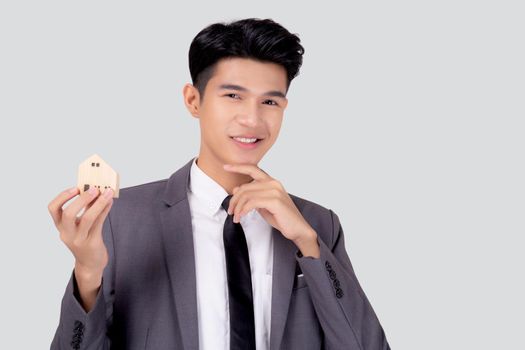 Young asian business man thinking idea and holding the home symbol of planning saving for future, insurance agent and credit, debt and loan of finance, home and refinance, investment real property.