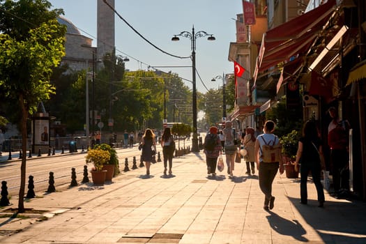 People walk along the sidewalk at Sultanahmet Square in Istanbul. Turkey , Istanbul - 21.07.2020