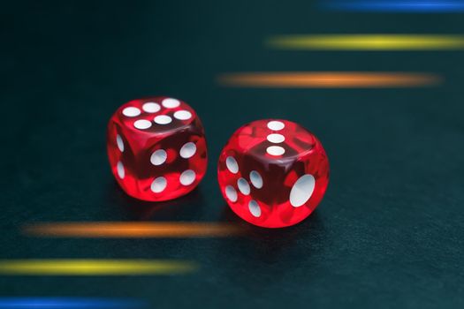 Red dice made of plastic for gambling lie on the table. Dice gambling in casino