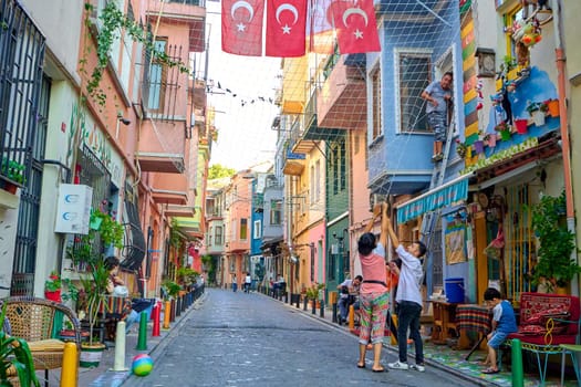 Ordinary life in the old district of istanbul. On the street, people are pulling a net to germinate plants and create shade. Turkey , Istanbul - 21.07.2020