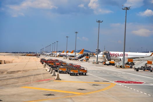 Carts for transportation and loading of passengers' belongings on the plane in the parking lot near the plane. Airport special transport. Turkey , Istanbul - 21.07.2020