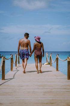 Curacao Caribbean Island, Kokomo Beach Views around the Caribbean island of Curacao on a bright day, couple mid age in swim short on the beach, men and woman on vacation at the beach