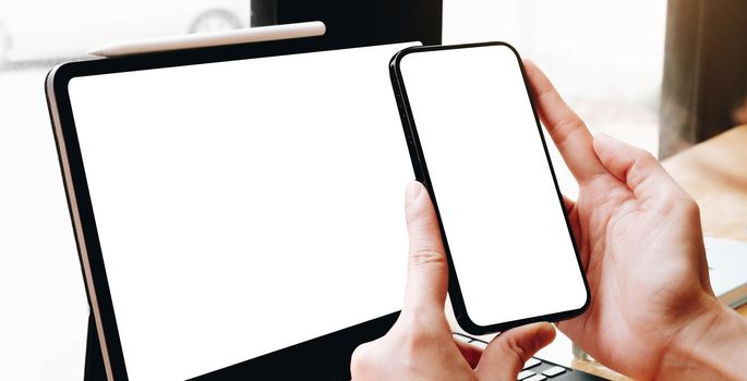 cell phone mockup. hand woman work using laptop texting mobile.blank screen with white background for advertising,contact business search information on desk in cafe.
