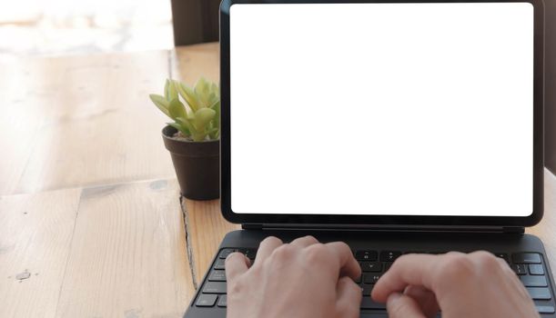 Mockup image of a woman using and typing on laptop computer with blank white desktop screen
