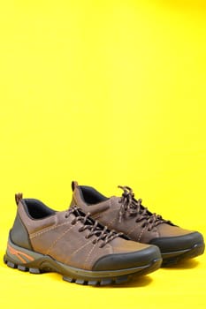 Men's shoes. Stylish men's shoes, sneakers in isolation, on a yellow background, levitation. High quality photo