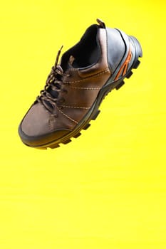 Men's shoes. Stylish men's shoes, sneakers in isolation, on a yellow background, levitation. High quality photo