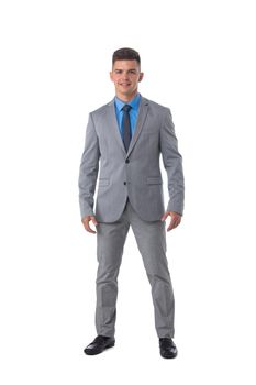 Full length portrait of a young business man in gray suit isolated on white background