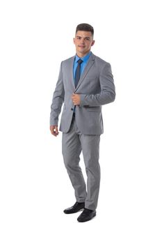 Full length portrait of a young business man in gray suit isolated on white background