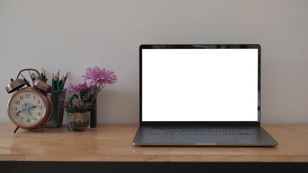 Blank screen Laptop computer and poster workspace background in modern office.	
