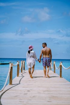 Curacao Caribbean Island, Kokomo Beach Views around the Caribbean island of Curacao on a bright day, couple mid age in swim short on the beach, men and woman on vacation at the beach