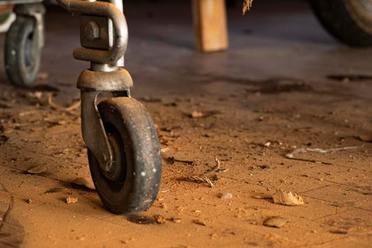 Detail of the wheel of a cart in an abandoned place, Evocative image of an abandoned place