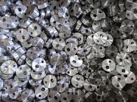 full frame view on heap of round steel cylindrical parts after eccentric drilling.