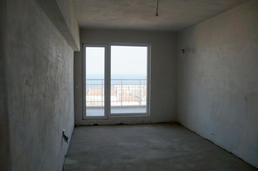 empty plastered room with window renovation concept.