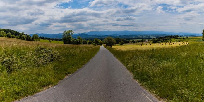 Long path with bushes and fields around in Kaczawskie mountains