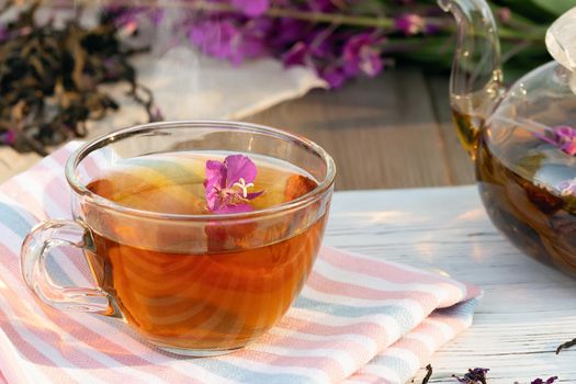 Herbal tea made from fireweed known as blooming sally in teapot and cup.