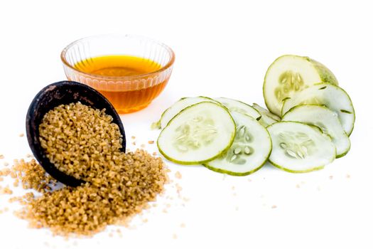 Cucumber face pack or face mask isolated on white with its entire ingredients which are oats and honey along with cucumber pulp well mixed in a glass bowl.Good for dry skin.